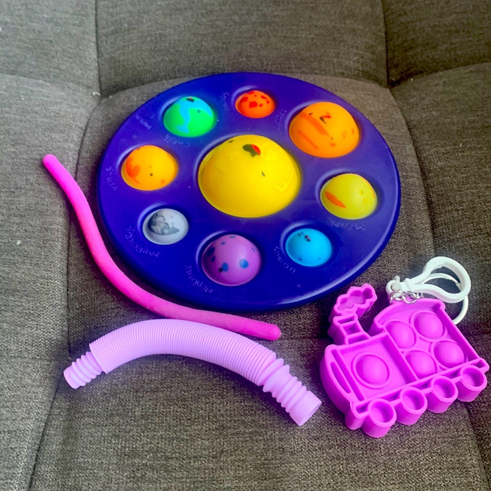 One galaxy dimple,one purple monkey noodle,one pop tube and one mini popit train